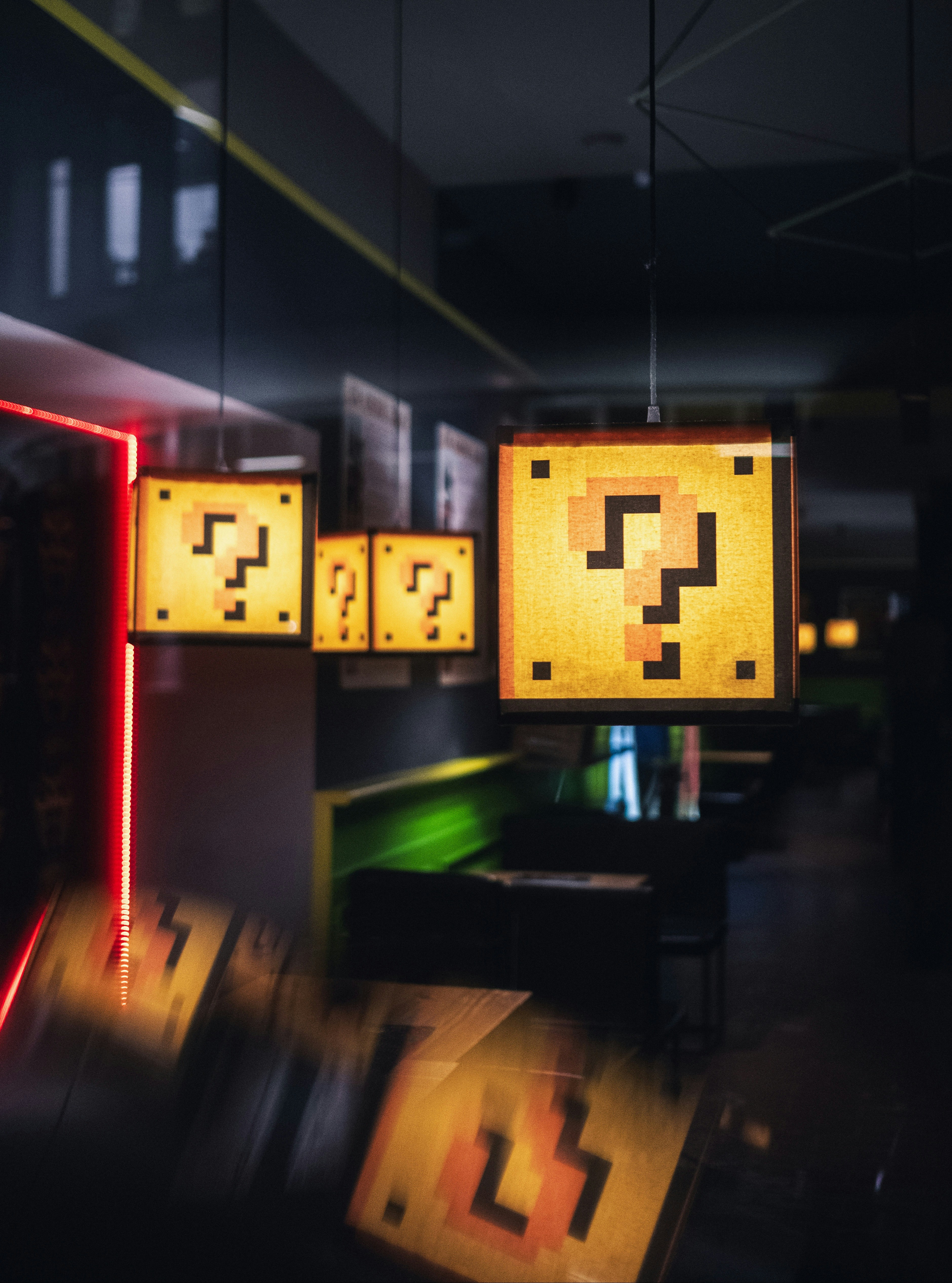 Pixelated question-mark blocks glowing in a dark room, evoking the feeling of unfamiliar terms appearing in a meeting.